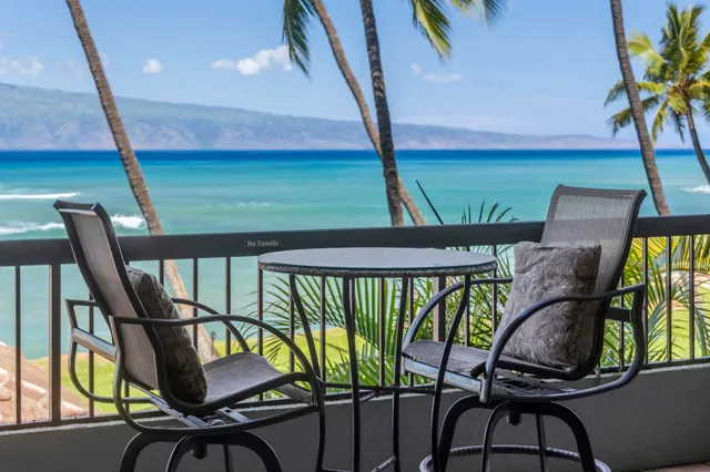 a large bed sitting in a bedroom next to a window