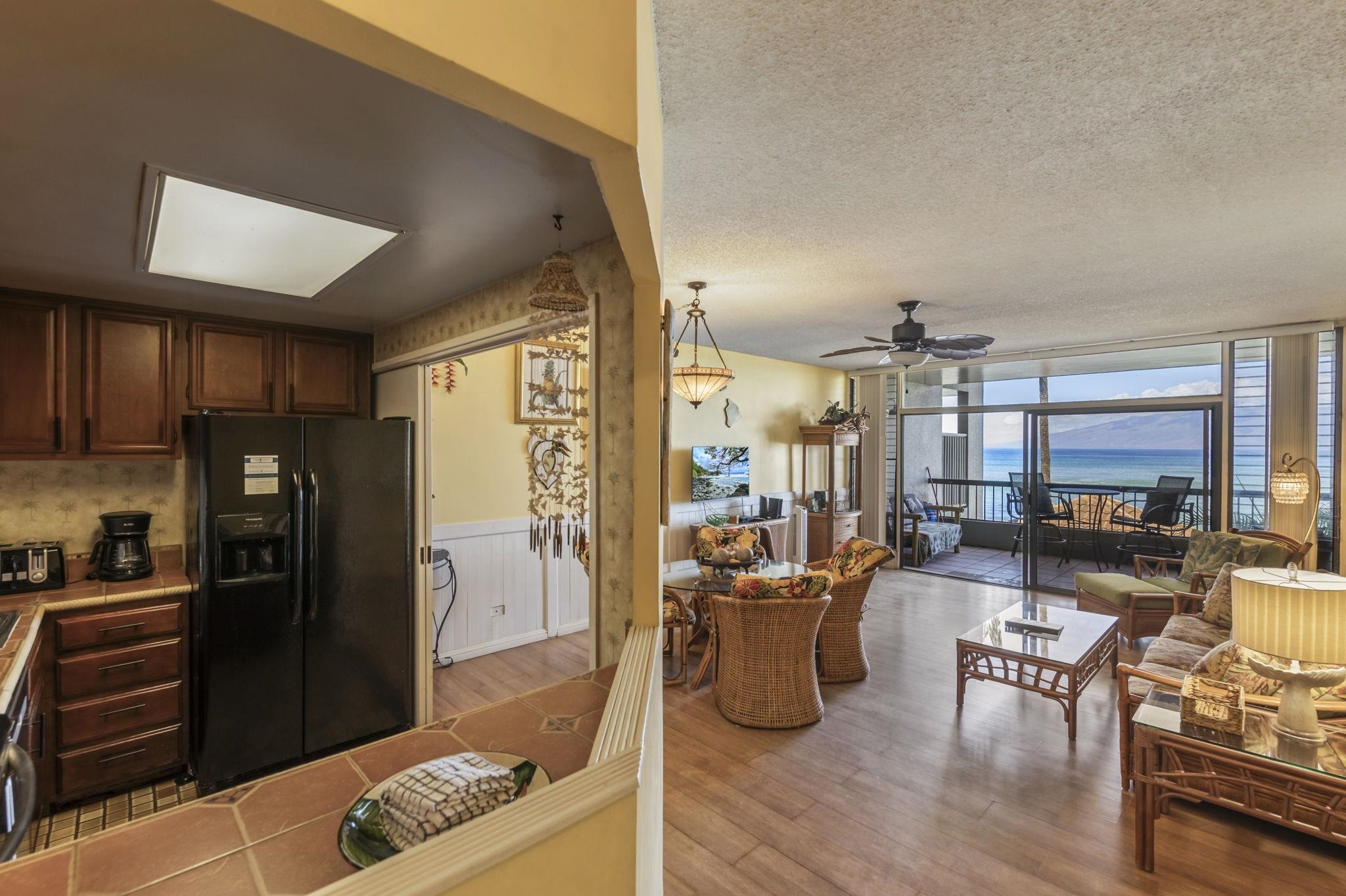 3875 Lower Honoapiilani Road, Unit B205 Lahaina, HI 96761 - Photo 7 of 28 a living room with furniture and a kitchen view