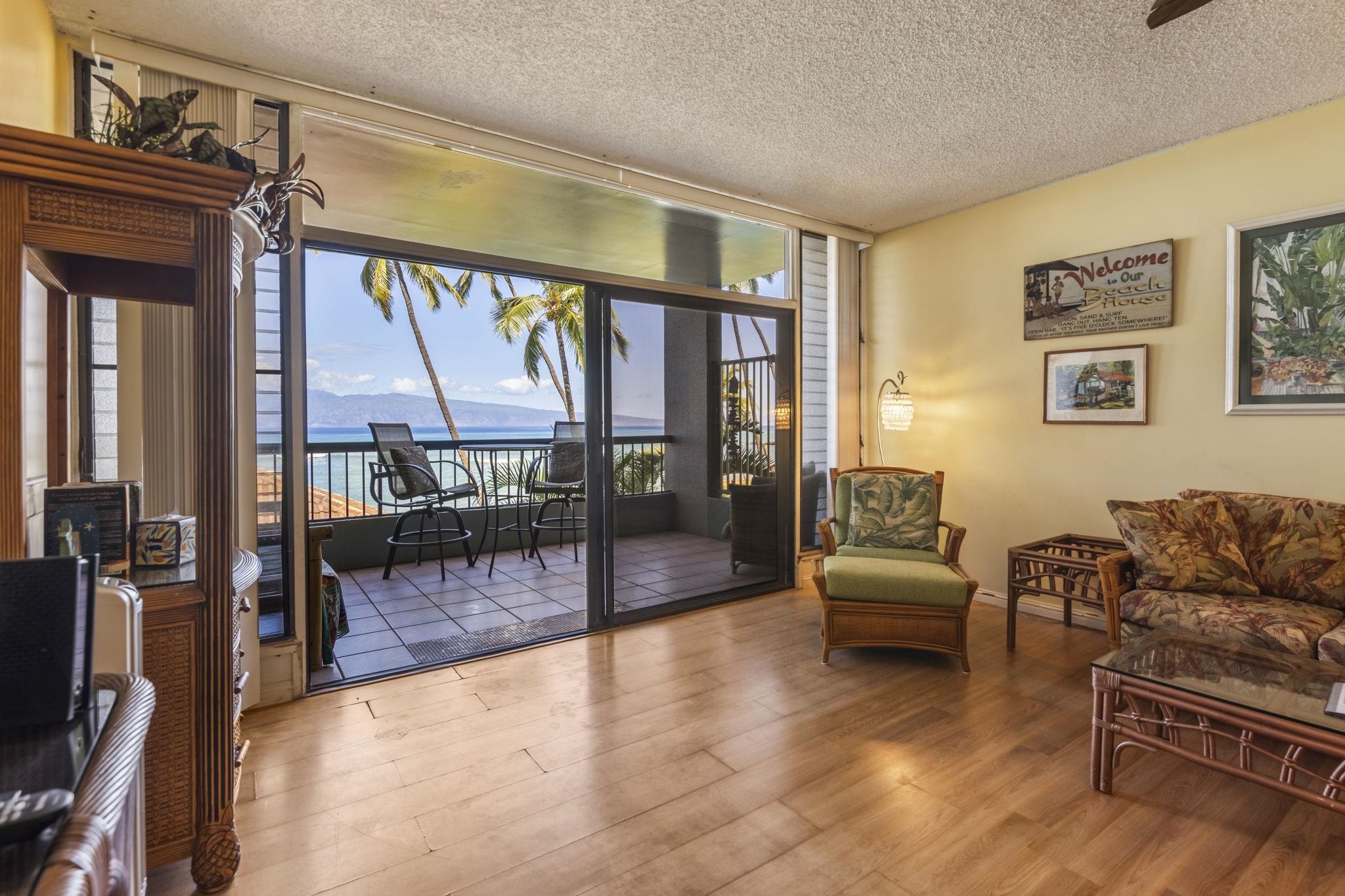 3875 Lower Honoapiilani Road, Unit B205 Lahaina, HI 96761 - Photo 10 of 28 a living room with furniture and a floor to ceiling window