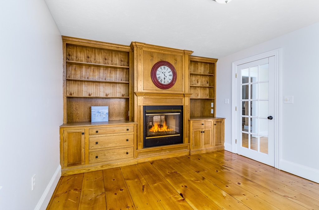 26 Chipman Road Sandwich, MA 02563 - Photo 12 of 30 a view of a kitchen with furniture and a fireplace