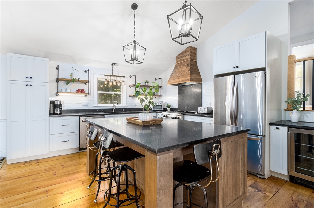 26 Chipman Road Sandwich, MA 02563 - Photo 8 of 30 a kitchen with stainless steel appliances a table chairs stove and cabinets