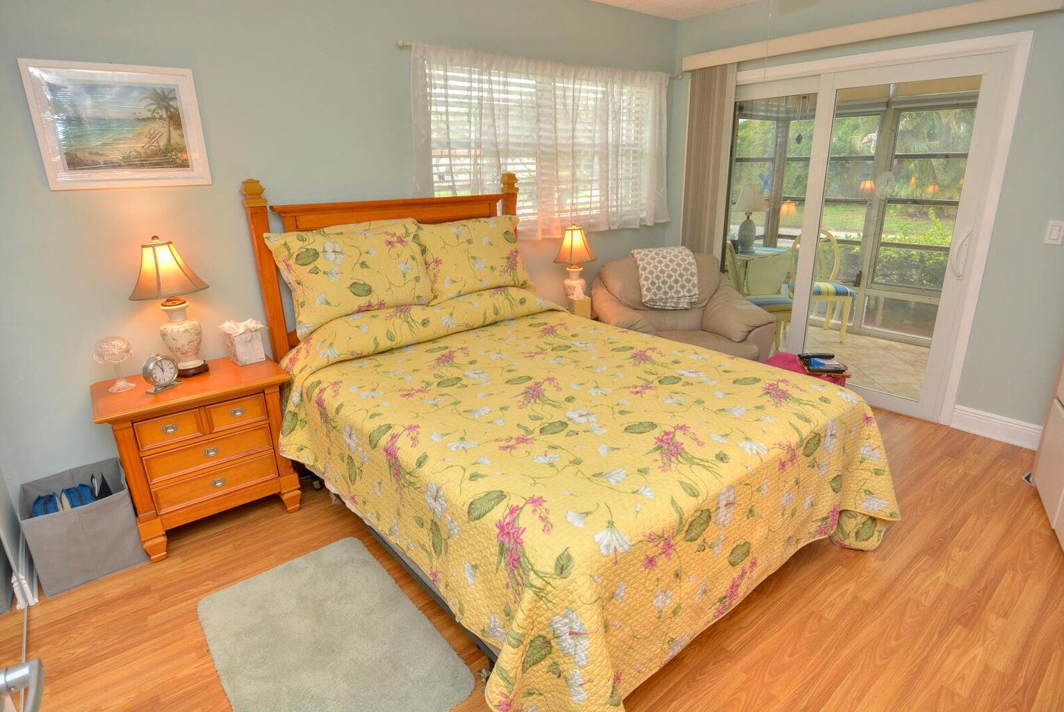 1225 Northwest 21st Street, Unit 2602 Stuart, FL 34994 - Photo 12 of 24 a large bed sitting in a bedroom next to a window