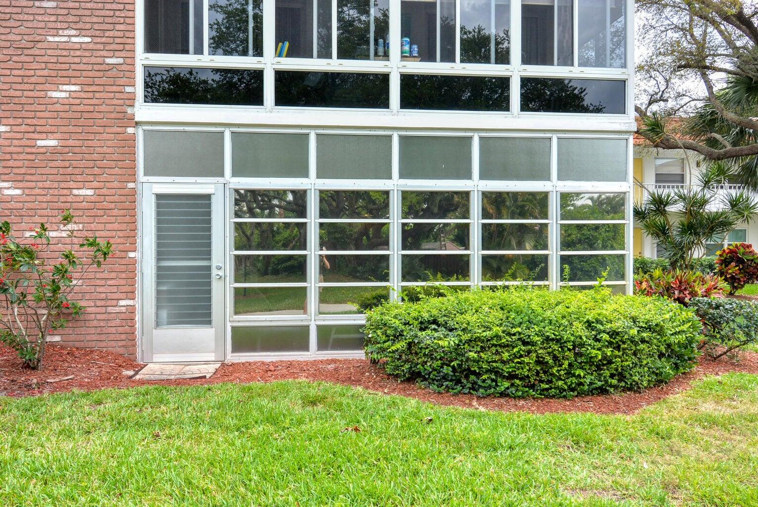 1225 Northwest 21st Street, Unit 2602 Stuart, FL 34994 - Photo 16 of 24 a view of a garden with a large window