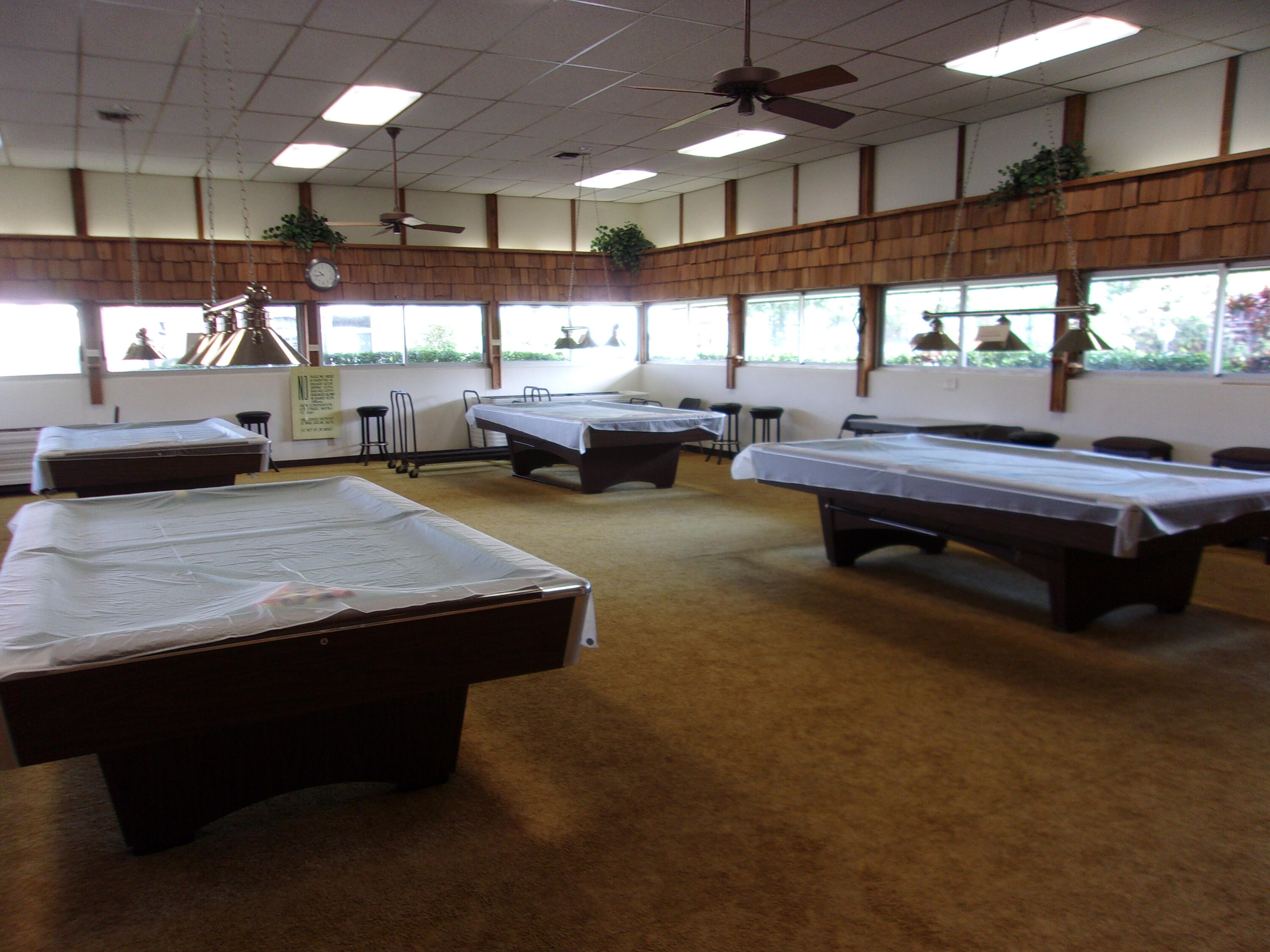 1225 Northwest 21st Street, Unit 2602 Stuart, FL 34994 - Photo 19 of 24 a room with lots of table and chairs