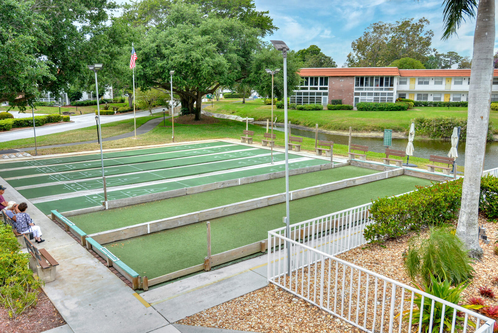 1225 Northwest 21st Street, Unit 2602 Stuart, FL 34994 - Photo 22 of 24 a view of a swimming pool with a garden