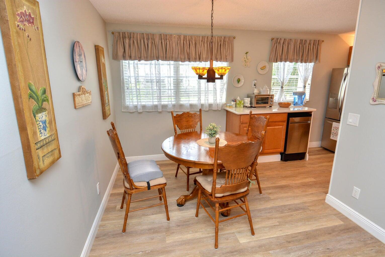 1225 Northwest 21st Street, Unit 2602 Stuart, FL 34994 - Photo 3 of 24 a dining room with furniture and window