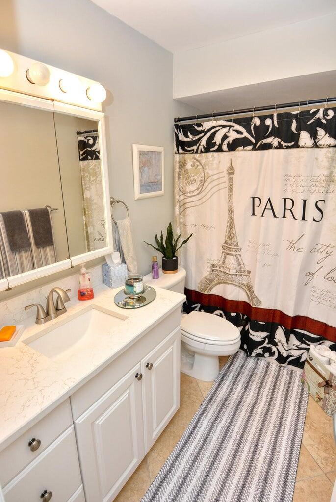 1225 Northwest 21st Street, Unit 2602 Stuart, FL 34994 - Photo 8 of 24 a bathroom with a sink and a mirror