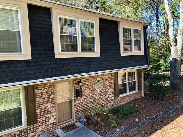 a view of a hallway with wooden floor and entryway