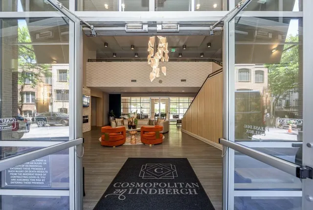 a view of a balcony with dining area and glass door