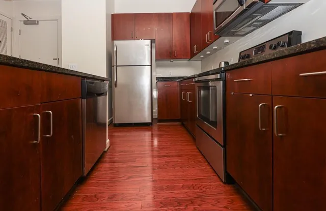 a view of a refrigerator and wooden floor