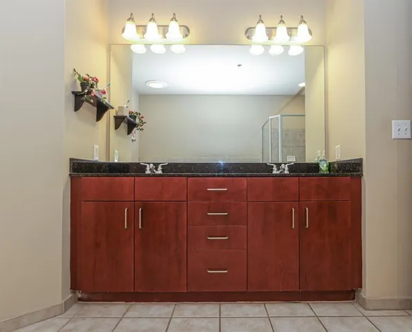 a bathroom with a sink vanity and mirror
