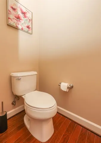 a white toilet sitting next to a small bathroom