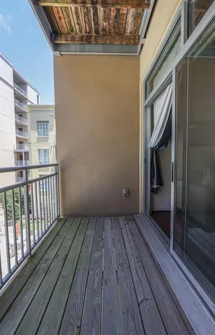 a view of a balcony with wooden floor
