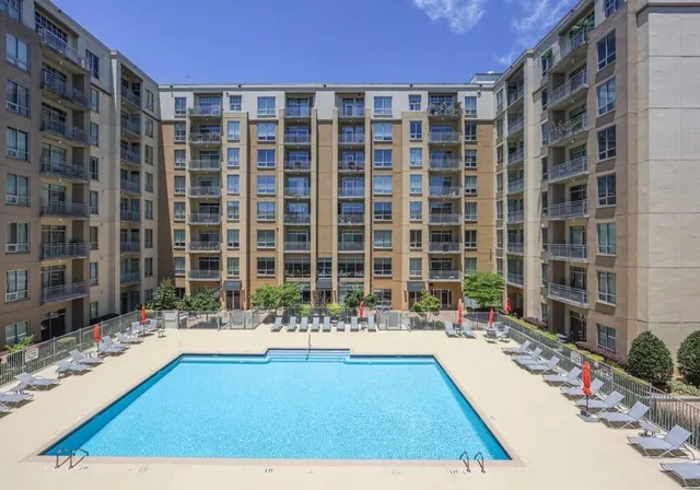 a large building with swimming pool in front of it