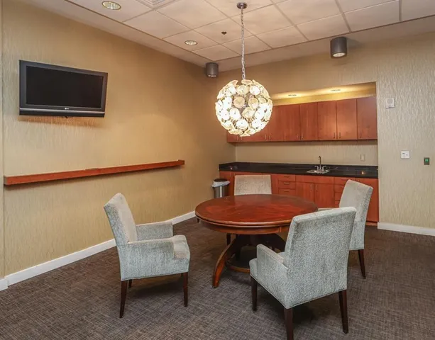 a view of a dining room with furniture and chandelier