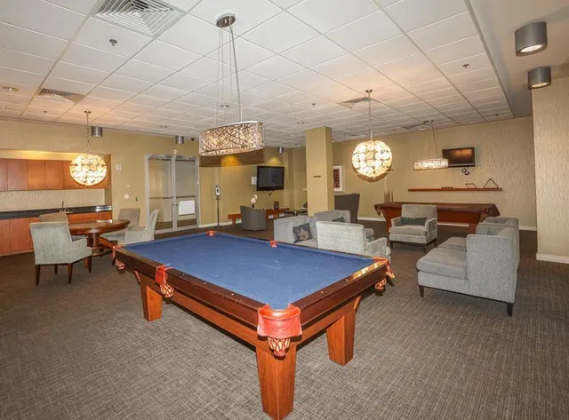 a room with table tennis pool table and chairs