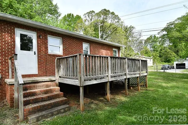 a view of a house with a yard and sitting area