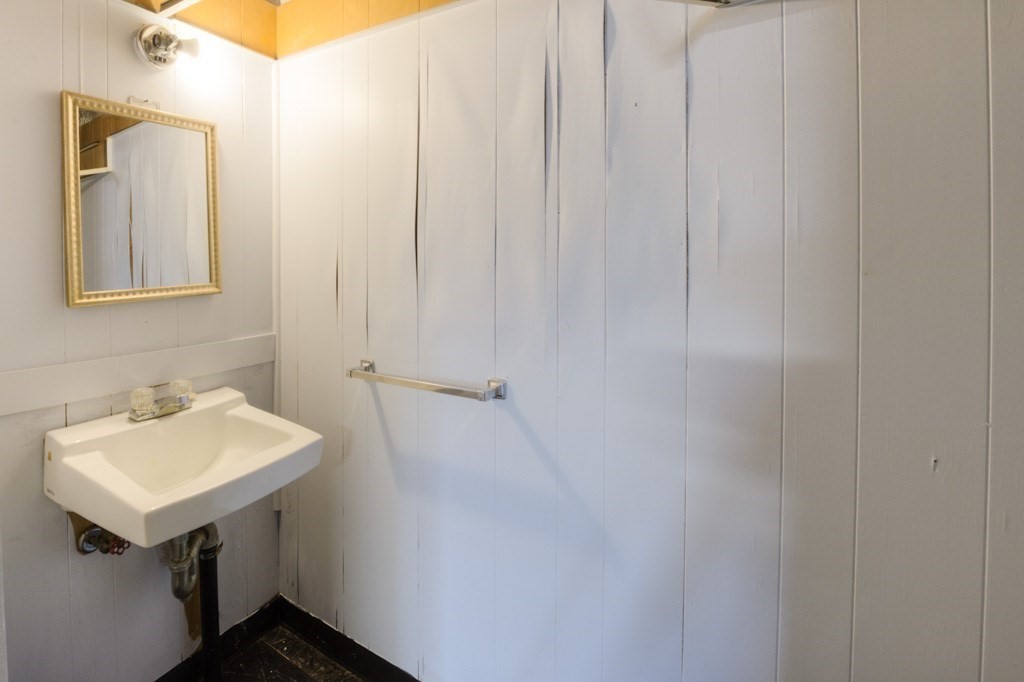 11 St Elmo Road Worcester, MA 01602 - Photo 28 of 34 a bathroom with a sink a mirror and a shower