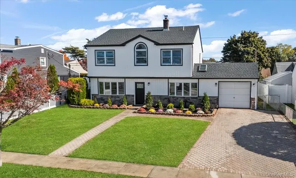 a front view of a house with a yard table and chairs