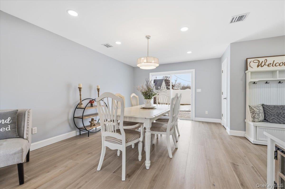 89 Ridge Lane Levittown, NY 11756 - Photo 42 of 44 a view of a dining room with furniture and wooden floor
