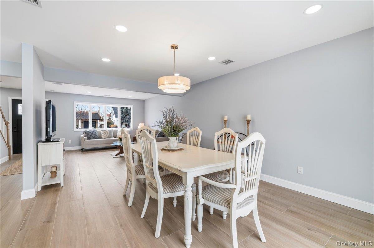 89 Ridge Lane Levittown, NY 11756 - Photo 12 of 44 a view of a dining room with furniture and wooden floor