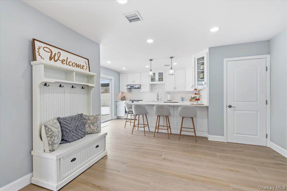 89 Ridge Lane Levittown, NY 11756 - Photo 43 of 44 a living room with furniture and a wooden floor
