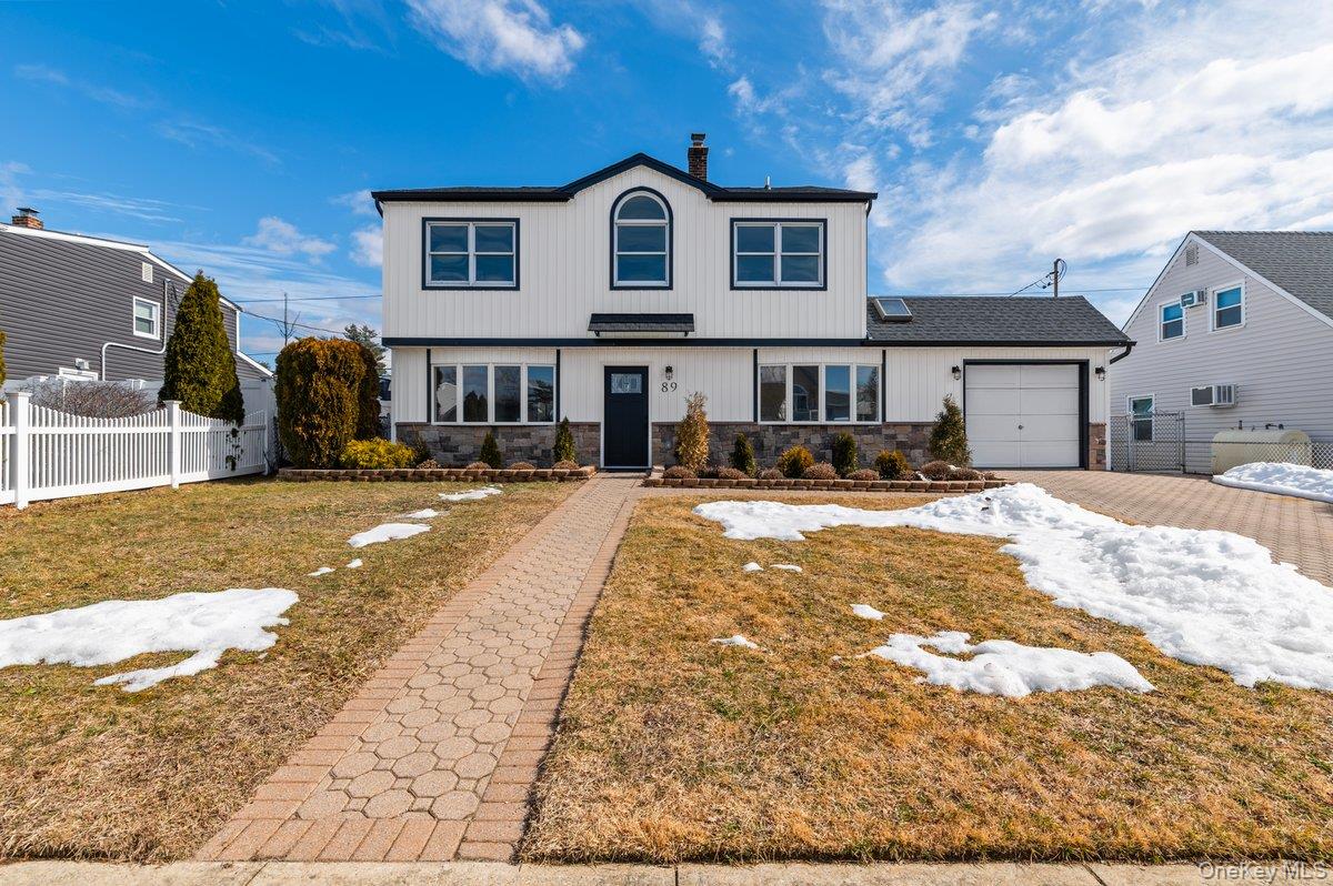 89 Ridge Lane Levittown, NY 11756 - Photo 2 of 44 a front view of a house with a yard