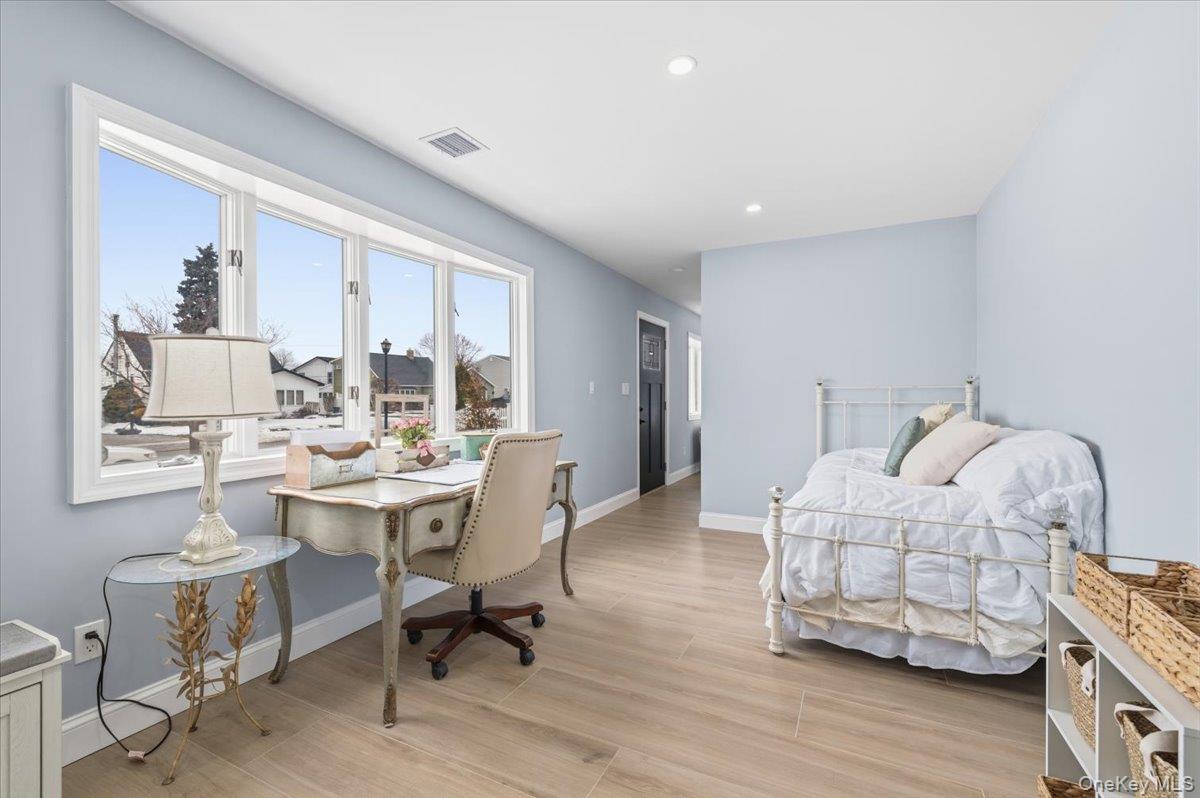 89 Ridge Lane Levittown, NY 11756 - Photo 18 of 44 a living room with furniture and wooden floor