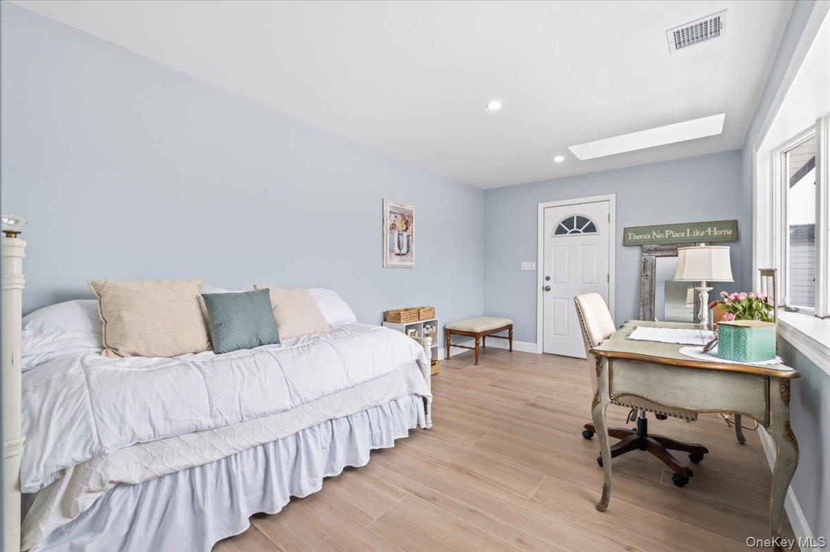 89 Ridge Lane Levittown, NY 11756 - Photo 19 of 44 a room with a bed a table and a chair