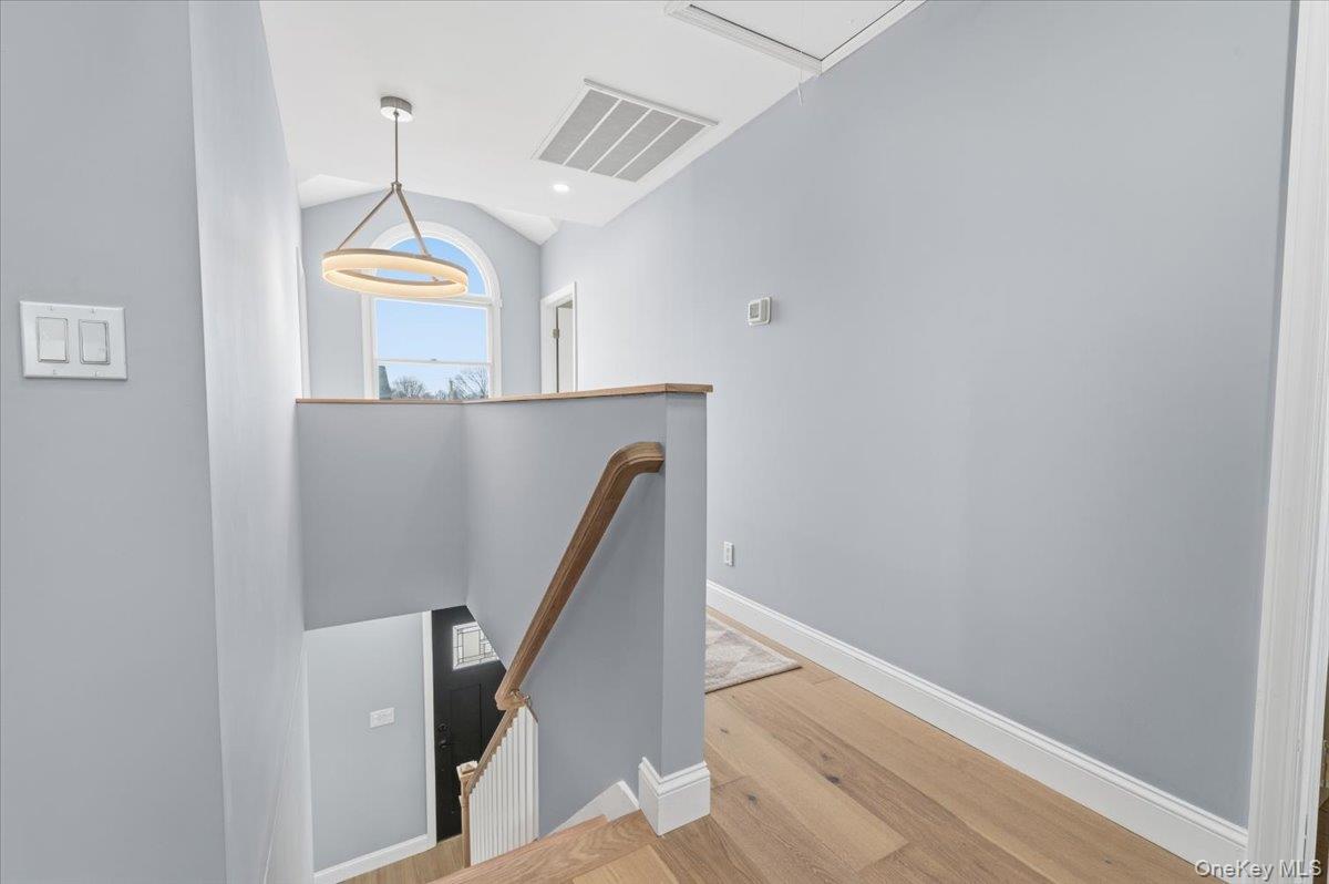 89 Ridge Lane Levittown, NY 11756 - Photo 22 of 44 a view of a hallway with stairs