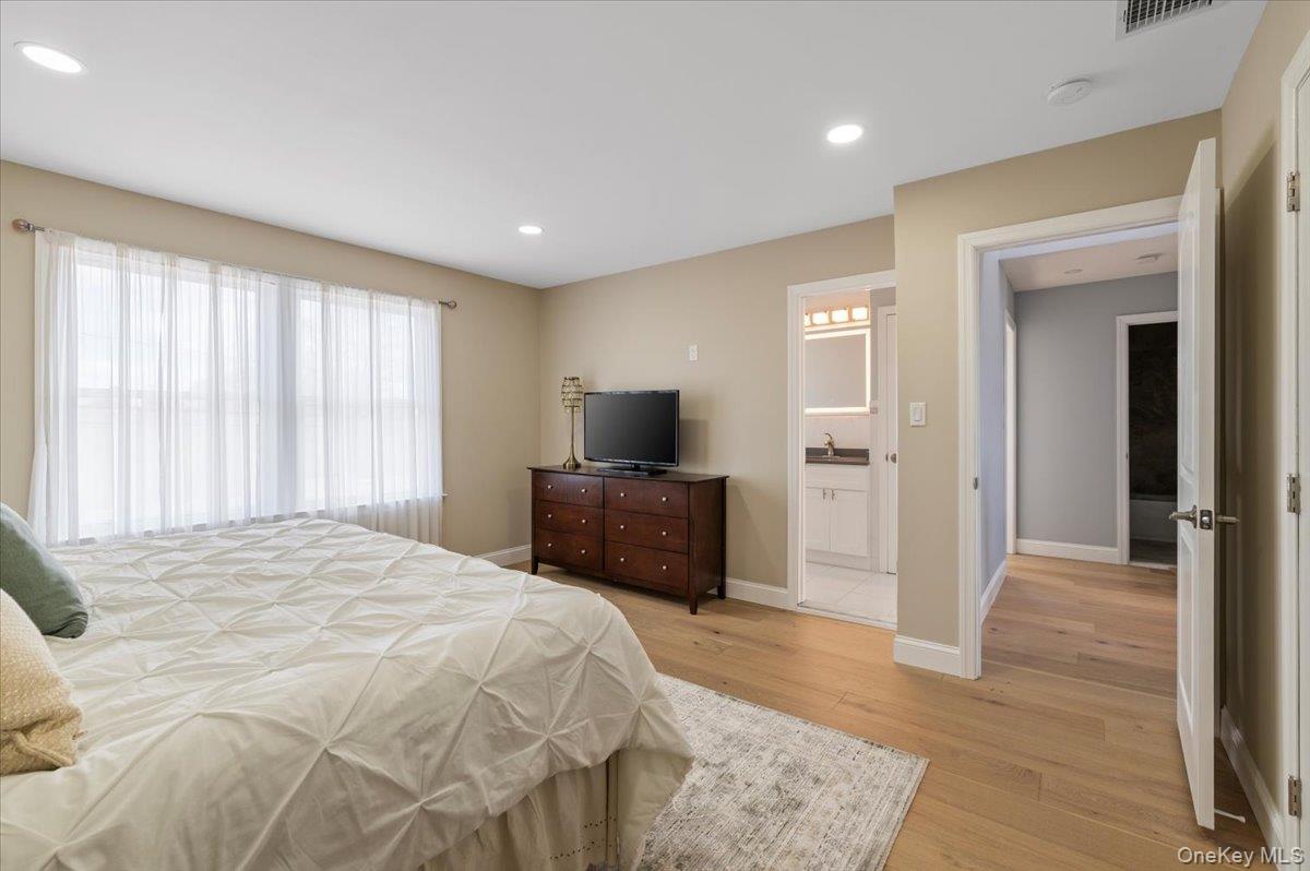 89 Ridge Lane Levittown, NY 11756 - Photo 26 of 44 a bedroom with a bed and a television in it