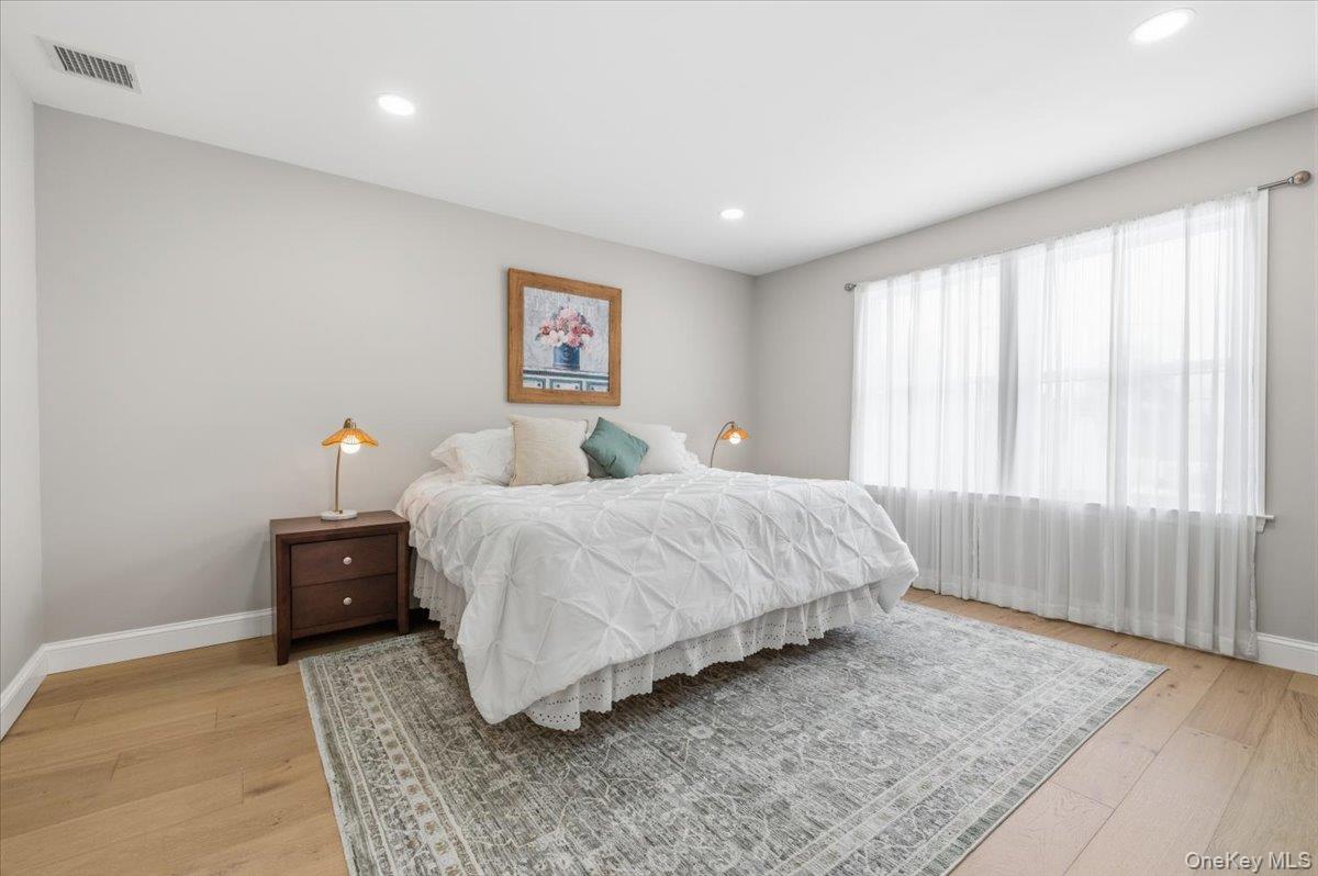 89 Ridge Lane Levittown, NY 11756 - Photo 27 of 44 a bedroom with a bed and window