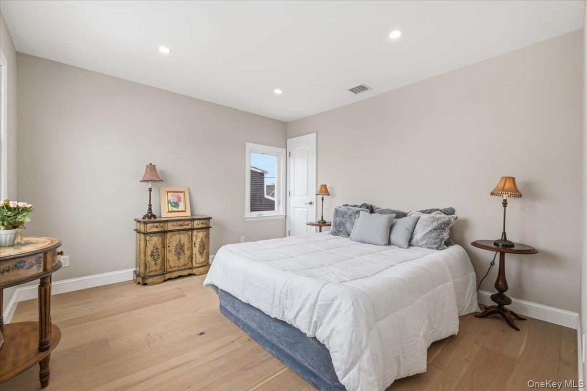 89 Ridge Lane Levittown, NY 11756 - Photo 28 of 44 a bedroom with a bed and a table