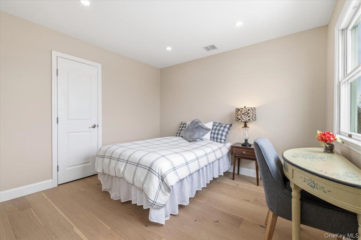 89 Ridge Lane Levittown, NY 11756 - Photo 31 of 44 a bedroom with a bed and a table