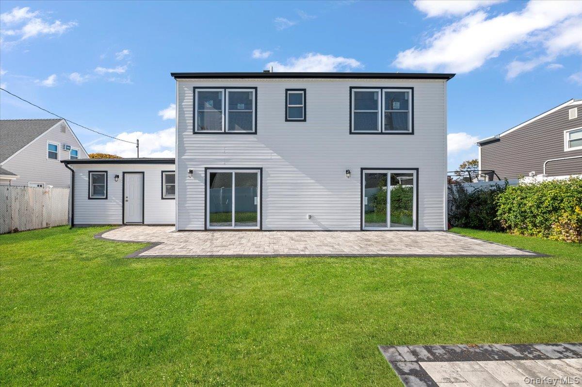 89 Ridge Lane Levittown, NY 11756 - Photo 37 of 44 a front view of a house with a garden and yard