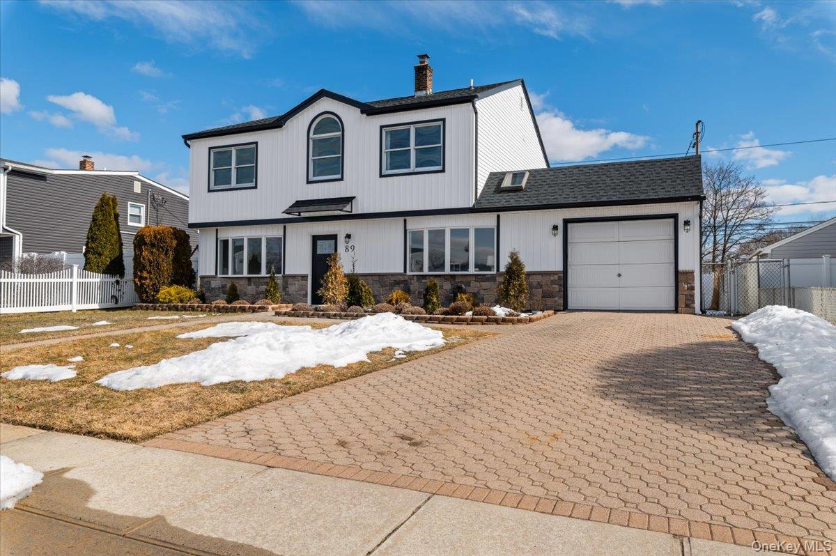 89 Ridge Lane Levittown, NY 11756 - Photo 4 of 44 a view of a building with a snow on the road