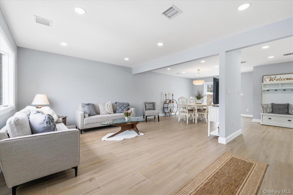 89 Ridge Lane Levittown, NY 11756 - Photo 6 of 44 a living room with furniture and wooden floor