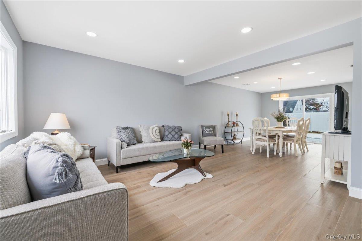 89 Ridge Lane Levittown, NY 11756 - Photo 7 of 44 a living room with furniture and a wooden floor