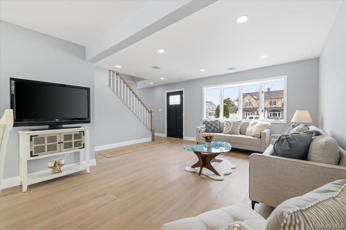 89 Ridge Lane Levittown, NY 11756 - Photo 8 of 44 a living room with furniture and a flat screen tv