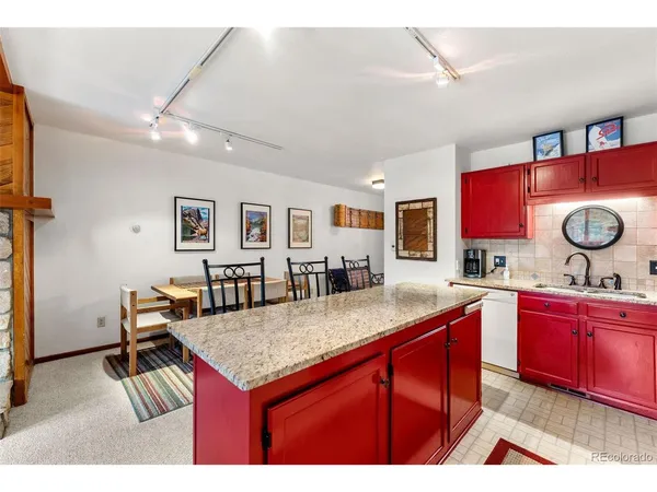 a kitchen with granite countertop a sink and cabinets