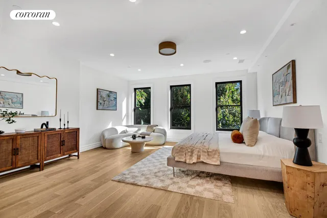 a living room with furniture and large windows