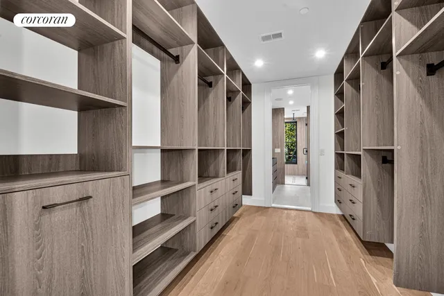 a view of walk in closet with empty racks