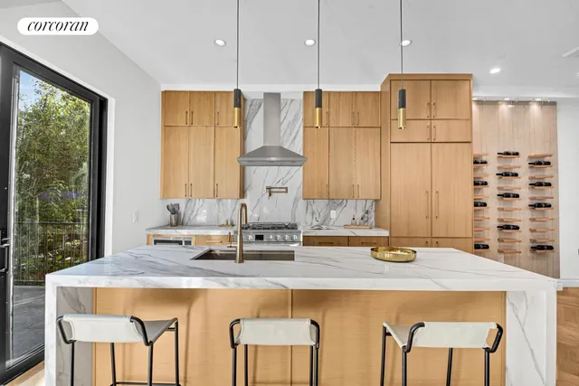 a large kitchen with a lot of cabinets and wooden floor
