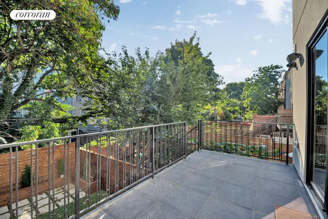 a large kitchen with a lot of cabinets and wooden floor