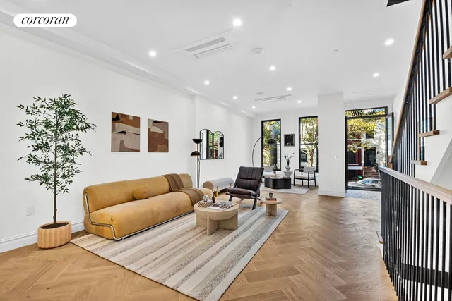 a living room with furniture and a potted plant