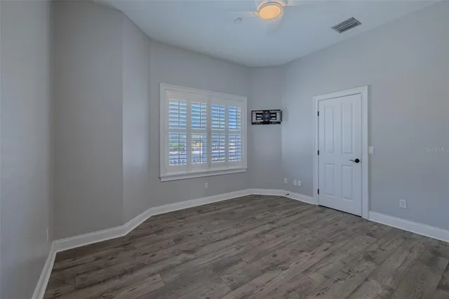 a bathroom with a granite countertop toilet a sink and a mirror