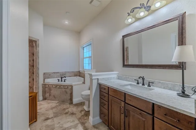 a kitchen with stainless steel appliances granite countertop a sink a stove and a refrigerator