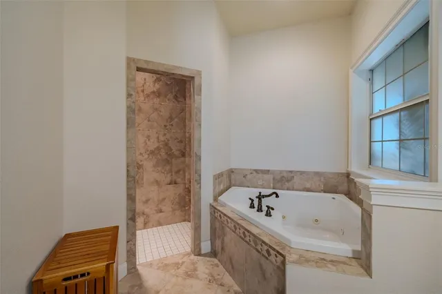 a kitchen with stainless steel appliances granite countertop a stove a sink a refrigerator and a wooden cabinets