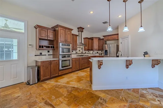 a view of a room with a chandelier furniture and windows