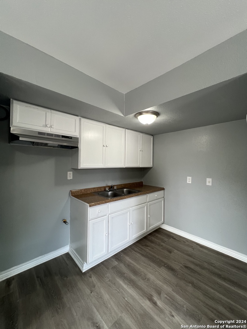 1723 West Mayfield Boulevard, Unit 4 San Antonio, TX 78211 - Photo 6 of 14 a kitchen with stainless steel appliances granite countertop a stove and a sink